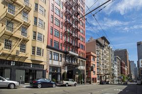 San Francisco apartment for rent - A street view of a city with cars and buildings.