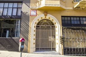 San Francisco apartment for rent - A building with a gate and a sign that says "RENT NOW".
