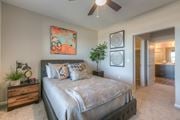 Lenexa apartment for rent - bedroom with ceiling fan and hallway to the bathroom  at EdgeWater at City Center, Lenexa, KS
