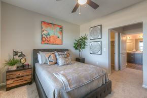 Lenexa apartment for rent - bedroom with ceiling fan and hallway to the bathroom  at EdgeWater at City Center, Lenexa, KS