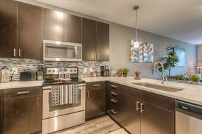 Lenexa apartment for rent - a kitchen with stainless steel appliances and white countertops  at EdgeWater at City Center, Lenexa, KS, 66219