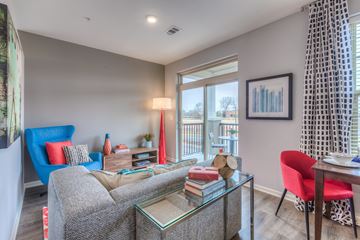 Lenexa apartment for rent - a living room with a couch and a table and a window
