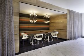 Hillsboro apartment for rent - a dining room with a wooden wall and a wooden table with white chairs