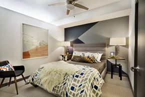Hillsboro apartment for rent - a bedroom with a large bed and a ceiling fan
