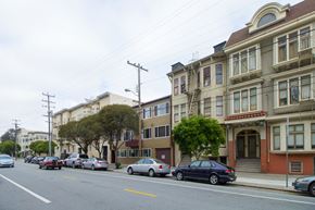 San Francisco apartment for rent - A street with cars parked on the side and buildings on the side.