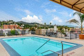 Los Angeles apartment for rent - a swimming pool at a resort with a city in the background