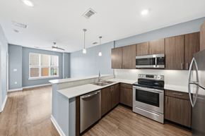 Omaha apartment for rent - A modern kitchen with stainless steel appliances and wooden cabinets.