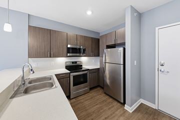 Omaha apartment for rent - A kitchen with a sink, stove, oven, and refrigerator.