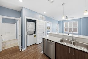 Omaha apartment for rent - A kitchen with a blue wall and white appliances.
