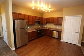 West Des Moines apartment for rent - a kitchen with stainless steel appliances and wooden cabinets