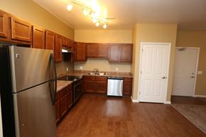 West Des Moines apartment for rent - a kitchen with stainless steel appliances and wooden cabinets