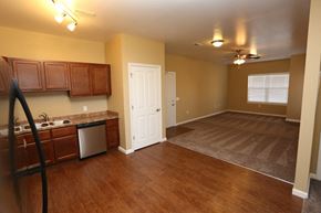 West Des Moines apartment for rent - an empty kitchen and living room with wood flooring