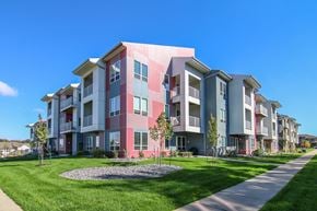 Madison apartment for rent - an apartment building with a green lawn and a sidewalk
