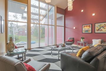 Madison apartment for rent - a living room with leather furniture and large windows