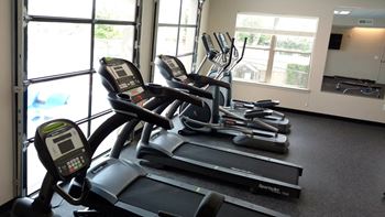 Fitness center on third floor with glass garage doors that open out to pool deck – currently the only apartments with a fitness center in lakeview.  Includes cardio machines, free weight machines, treadmills, ellipticals, bikes, kettle bells, and bosu balls.