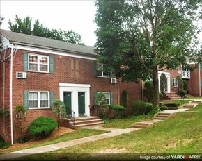Hasbrouck Heights apartment for rent - A brick house with green shutters and a white door.