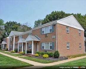 Allentown apartment for rent - A brick house with a front porch and a covered walkway.