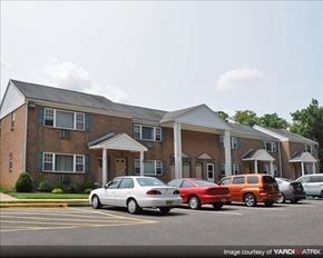 Allentown apartment for rent - A white car is parked in front of a brick building.