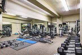 Baltimore apartment for rent - a gym with weights and cardio equipment in a large room