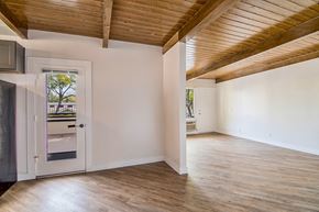 Los Angeles apartment for rent - an empty living room with white walls and a door to a balcony