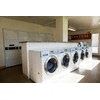 A row of washing machines in a laundromat.