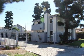 Paramount apartment for rent - a white house with a white fence and a gate