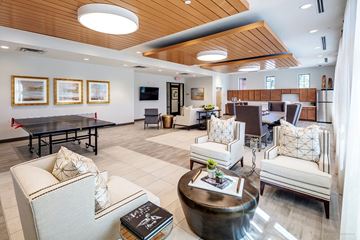 San Antonio apartment for rent - A spacious living room with a wooden ceiling and furnished with a sofa, armchairs, and a coffee table.