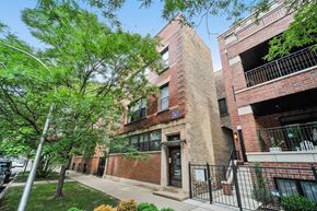 Chicago apartment for rent - a brick building with a sidewalk and trees in front of it