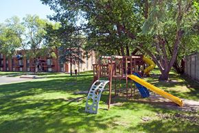 Coon Rapids apartment for rent - a playground with a playset and a slide in a park