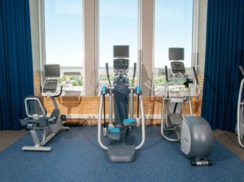 Fitness center with free weights, machines, and training studio