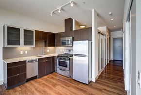 Seattle apartment for rent - A modern kitchen with wood floors and stainless steel appliances.