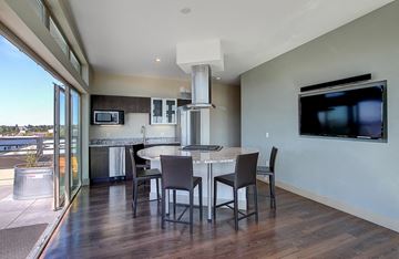 Seattle apartment for rent - A modern kitchen with a dining table and chairs.