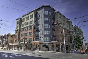 Seattle apartment for rent - A large multi-story building with a mix of brick and panel siding.