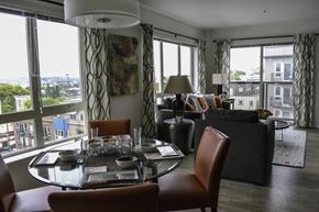 Seattle apartment for rent - A dining room with a table set for two and a view of the city.
