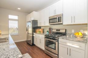Madison apartment for rent - a kitchen with stainless steel appliances and white cabinets
