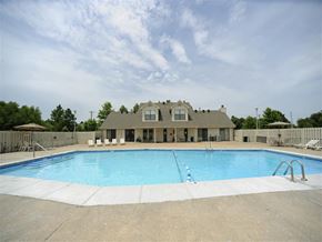 Fayetteville apartment for rent - a swimming pool with a house in the background