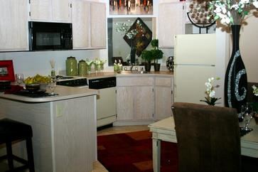 Fayetteville apartment for rent - A kitchen with white cabinets and a white refrigerator.