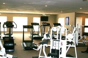 Fayetteville apartment for rent - A gym with treadmills, elliptical machines, and weight machines.