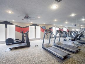 Conway apartment for rent - a gym with cardio machines and a ceiling fan