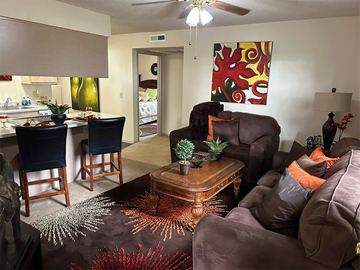 Bentonville apartment for rent - a living room with a couch and a table and a kitchen