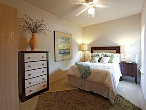 Fayetteville apartment for rent - a bedroom with a bed and a ceiling fan