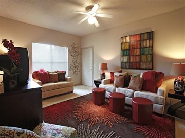 Fayetteville apartment for rent - a living room filled with furniture and a ceiling fan
