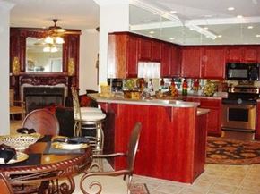 Fayetteville apartment for rent - A kitchen with red cabinets and a fireplace.