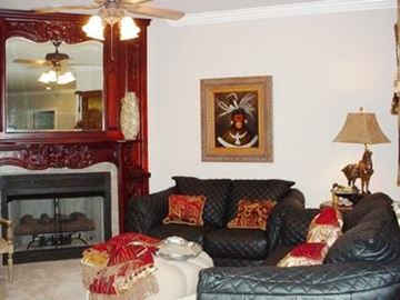 Fayetteville apartment for rent - A living room with a fireplace and a painting on the wall.