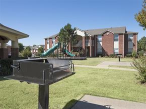 Springdale apartment for rent - a playground in front of a building with a green slide