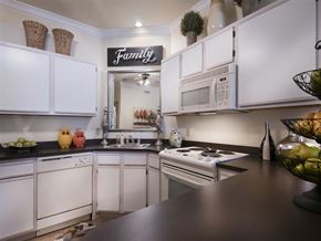 Springdale apartment for rent - a kitchen with white cabinets and a counter top