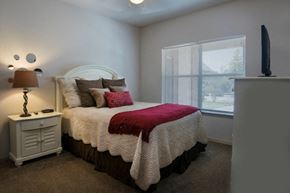 Fayetteville apartment for rent - a bedroom with a bed and a window