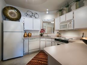 Canton apartment for rent - a kitchen with white cabinets and appliances and a counter top