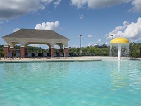 Starkville apartment for rent - a swimming pool with a water fountain and a pavilion