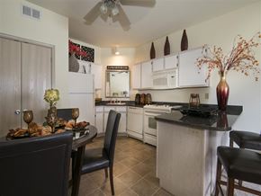 Starkville apartment for rent - a kitchen with white appliances and a table and chairs